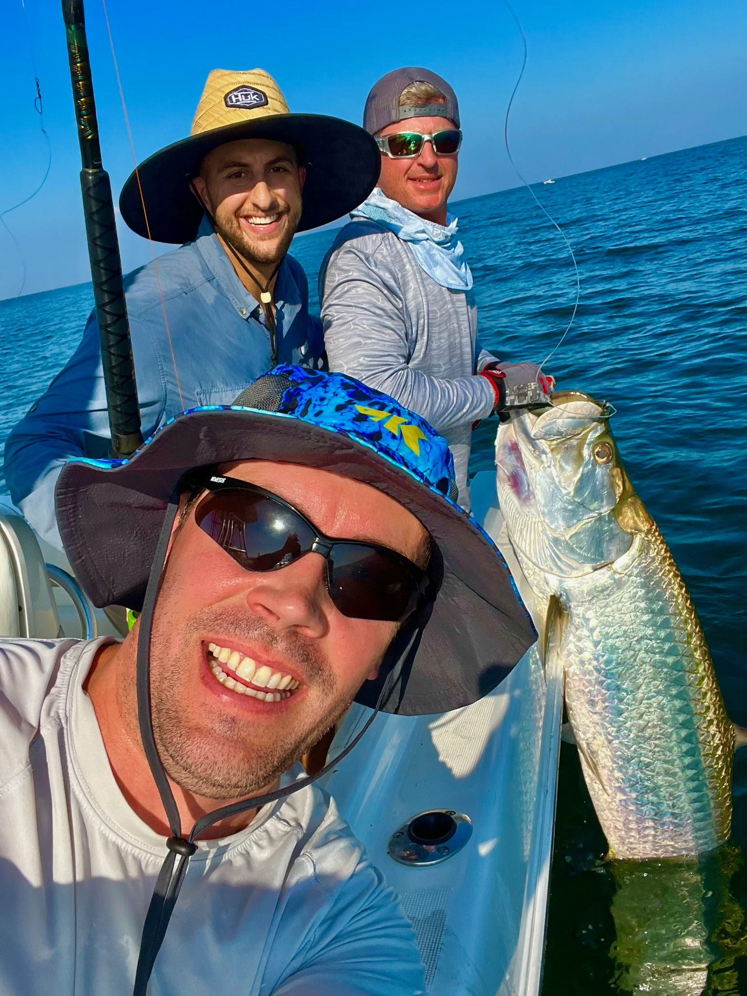 Happy anglers with tarpon on Galveston fishing trip